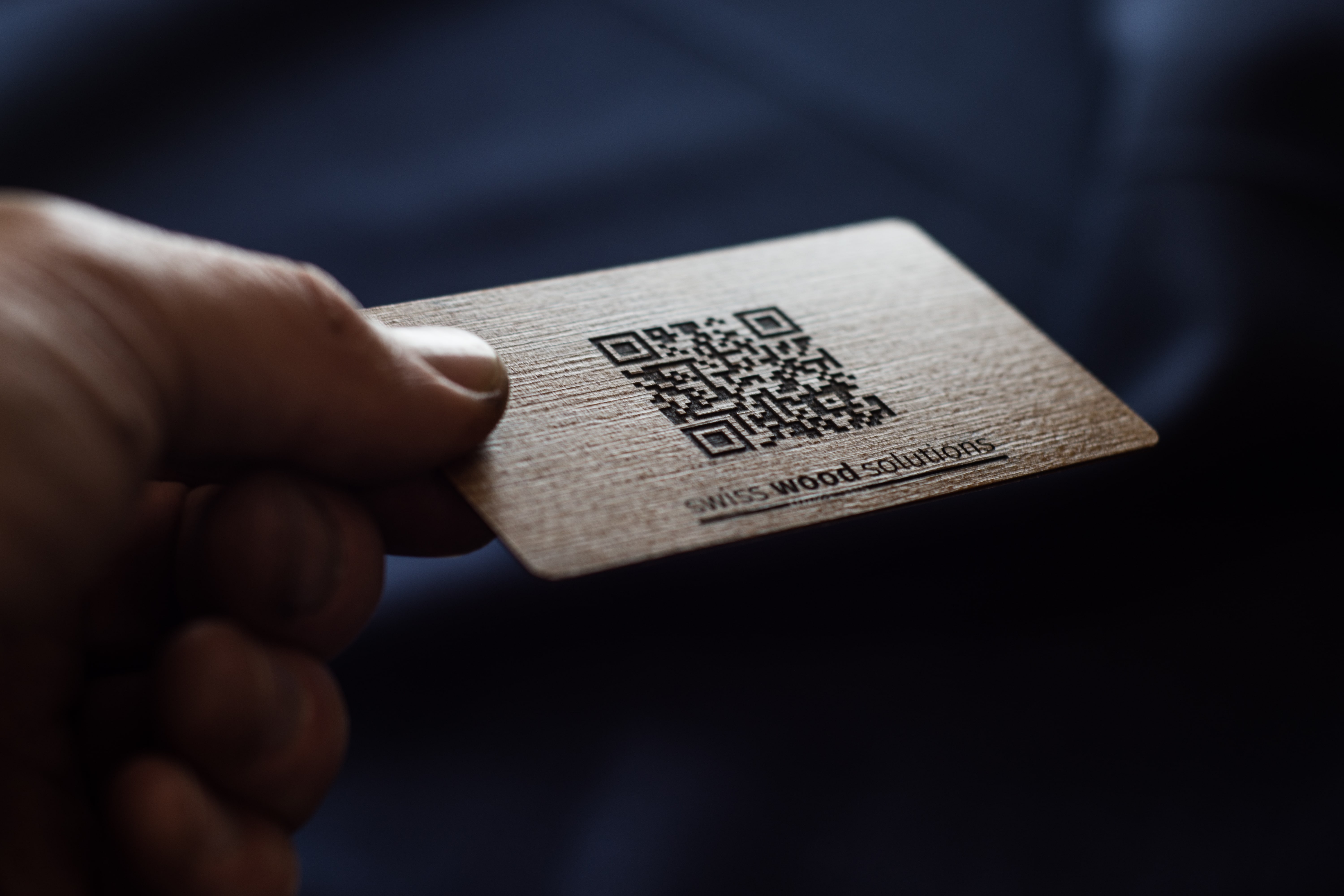 Swiss Wood Solutions business card with QR code from maple wood